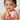 a baby in a bathtub holding a rubber duck