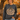 a woman standing in front of a pumpkin patch