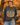 a woman standing in front of a pumpkin patch