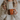 a woman holding two mugs