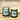 a couple of green candles on a wooden surface