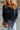 a woman wearing a blue sweater and jeans