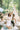 a woman in white dress with kids around her