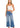 a woman in a white tank top and blue jeans