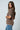 a woman in a brown sweater