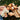 a woman and girl lying on grass with stuffed animals