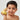 a boy holding a yellow rubber duck
