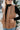 a woman wearing a brown vest