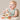 a baby sitting in a highchair with a toy